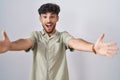 Arab man with beard standing over white background looking at the camera smiling with open arms for hug Royalty Free Stock Photo