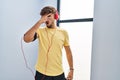 Arab man with beard wearing sportswear and headphones relaxed with serious expression on face Royalty Free Stock Photo