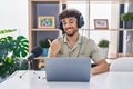 Arab man with beard working at the radio smiling with happy face looking and pointing to the side with thumb up Royalty Free Stock Photo