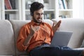 Arab man CEO working from home, using laptop and headset Royalty Free Stock Photo
