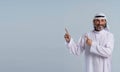 Arab man is with copy space. He is pointing his hands aside, indicating leadership, direction, and effective