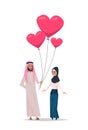 Arab man giving woman pink heart shape air balloons happy valentines day holiday concept arabic couple in love full