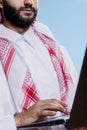 Arab man holding laptop, writing message Royalty Free Stock Photo