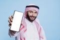 Arab man holding smartphone white screen