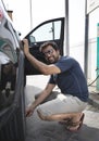 Arab man inflating car tyre