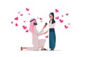 Arab man kneeling holding engagement ring proposing arabic woman marry him happy valentines day concept couple in love Royalty Free Stock Photo