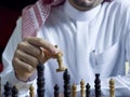 An Arab man playing chess at his desk 3 Royalty Free Stock Photo