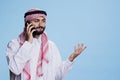 Man in arab clothes speaking on phone