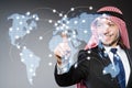 Arab man pressing dots on world map in global communication conc Royalty Free Stock Photo