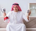 Arab man with prize and money on sofa Royalty Free Stock Photo