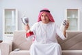 The arab man with prize and money on sofa Royalty Free Stock Photo