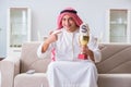 The arab man with prize and money on sofa Royalty Free Stock Photo