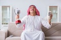 The arab man with prize and money on sofa Royalty Free Stock Photo