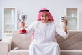 The arab man with prize and money on sofa Royalty Free Stock Photo