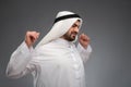 Arab man raising his hands being tired