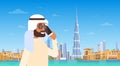 Arab Man Speaking On Cell Smart Phone Call Over Dubai Skyline Panorama, Modern Building Cityscape
