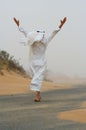 Arab man walking in sand storm Royalty Free Stock Photo