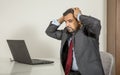 Arab man woking in his laptop in the kitchen