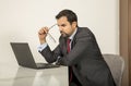 Arab man woking in his laptop in the kitchen