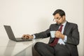 Arab man woking in his laptop in the kitchen