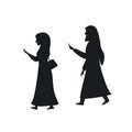 Arab man and woman walking with smartphones silhouettes