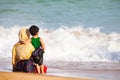 Arab mother and son hugging to the sea Royalty Free Stock Photo