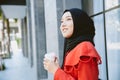 Arab Muslim Asian businesswoman young girl smiling hand hold coffee cup standing portrait