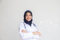 Arab Muslim doctor or nurse standing uniform white has stethoscope in the hospital, Portrait young hijab of a smiling area Royalty Free Stock Photo