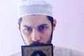 Arab muslim man with koran holy book Royalty Free Stock Photo