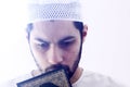 Arab muslim man with koran holy book Royalty Free Stock Photo