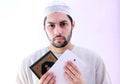 Arab muslim man with koran holy book and pc tablet Royalty Free Stock Photo