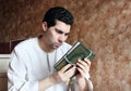 Arab muslim man with koran holy book with rosary Royalty Free Stock Photo