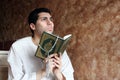 Arab muslim man with koran holy book with rosary Royalty Free Stock Photo