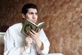 Arab muslim man with koran holy book with rosary Royalty Free Stock Photo