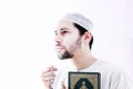 Arab muslim man with koran holy book and rosary Royalty Free Stock Photo