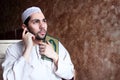 Arab muslim man with Koran islamic holy book and headset Royalty Free Stock Photo