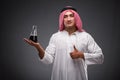 The arab with oil on gray background Royalty Free Stock Photo