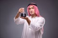 The arab with oil on gray background Royalty Free Stock Photo