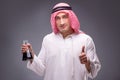 The arab with oil on gray background Royalty Free Stock Photo