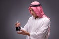 The arab with oil on gray background Royalty Free Stock Photo