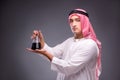 The arab with oil on gray background Royalty Free Stock Photo