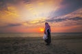 An arab old man standing in Fanateer beach with sunrise background. Al Jubail City -Saudi Arabia
