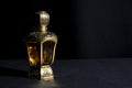 Arab perfume in a bottle, isolated in black background, in low l