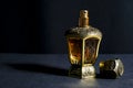 Arab perfume in a bottle, isolated in black background, in low l