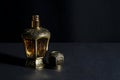 Arab perfume in a bottle, isolated in black background, in low l