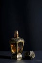 Arab perfume in a bottle, isolated in black background, in low l