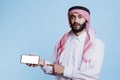Arab pointing at phone white screen