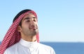 Arab saudi man breathing deep fresh air in the beach