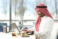 Arab saudi man working online with a laptop