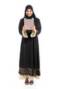 Arab saudi woman standing looking a tablet reader